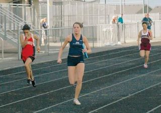 Rachel Carey bursts down the backstretch as the anchor leg of the girls 4x100m relay.