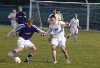 Richard Gonzalez defends in the midfield as Arlington slogged through tough field conditions in their match with Lake Stevens.