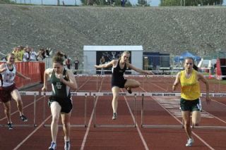Junior Amanda Wregglesworth jumps in the girls 300 hurdles.