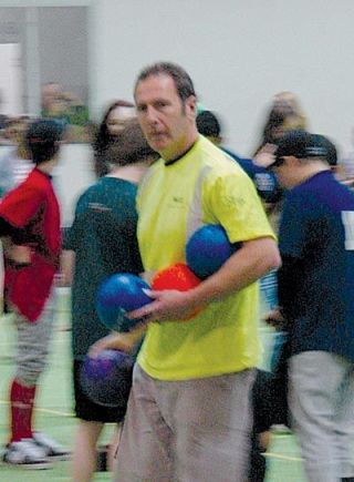 Dodgeball event organizer Bill Schwartz helps set up for another round of tournament play.