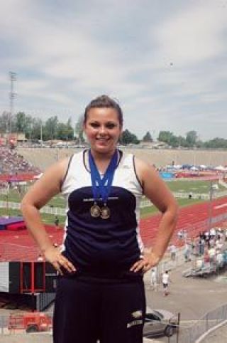 Junior Kjirsten Jensen dons her first-place medals for the states best shot put and discus performances.