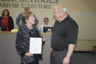 Arlington School District Superintendent Linda Byrnes receives a copy of House Resolution No. 4706 from state Rep. Kirk Pearson April 28.