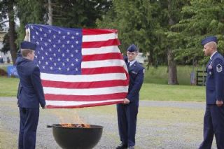 Members of the Air Force Junior ROTC of Arlington High School take part in retiring American flags at the Stillaguamish Valley Pioneer Museum June 14.