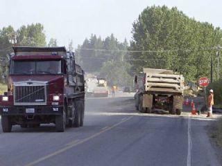 Gravel trucks buzz up and down SR 9 north of Arlington Monday morning in the last-minute effort to open the new bridge over Harvey Creek as part of the north of Arlington SR 9 expansion project. Work will continue on the left turn lanes at Kackman Road (252nd) and the Stanwood Bryant Road (268th) to be completed this fall.