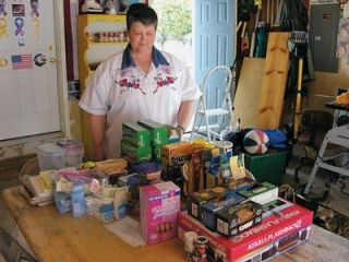 Suzie Carter proudly shows off her latest haul of supplies for American military members in Iraq