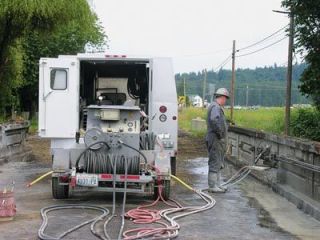 Fred Knierim of Cascade Sawing and Drilling removes the existing deck and railings on the north end of Bridge 91 on Smokey Point Boulevard.