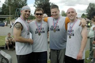 The local division champion team the Angry Dragons poses with their hardware after their win is announced. Pictured