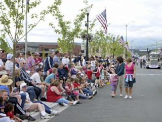 Crowds were four to six people deep as people waited anxiously for big trucks along North Olympic Avenue for the Fourth of July Grand Parade