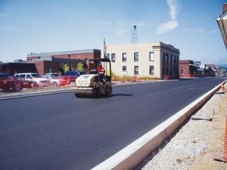 A first coat of asphalt is laid in front of City Hall on the second phase of the Olympic Avenue project