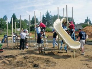 Three community service groups come together in Jensen Park Aug. 11 to assemble and install playground swings