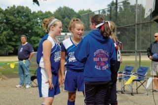 Anna Larson and Alexis Blakey recite the Little League pledge along with two members of San Marinos team prior to the matchup between the teams.