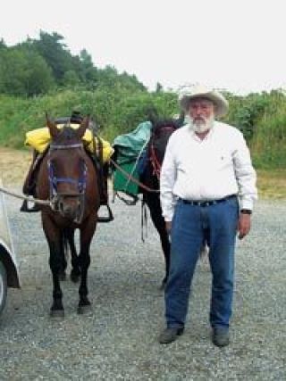 Gene Glascock prepares to ride his horse