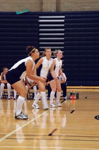 The Arlington Eagles back row prepares to return serve during their recent loss to Burlington-Edison.