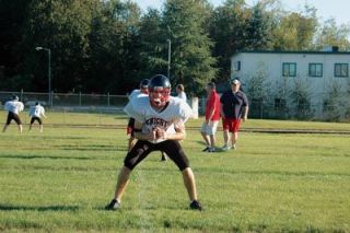HCA halfback Jeff Kelly gets in an athletic stance as part of a drill for Highland Christian.