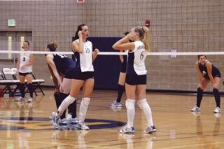 Middle hitter Breanna Covey discusses strategy with setter Kelsey Czban during the teams Sept. 20 match with Meadowdale.