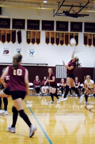 Juliet Dvorak swings through a midcourt spike for the Cougars in their match with Kings.