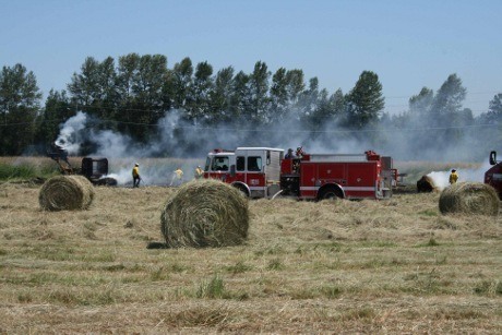 Marysville Fire District crews work to extinguish a grass fire the size of a football field in the area of 156th Street NE and 23rd Avenue NE