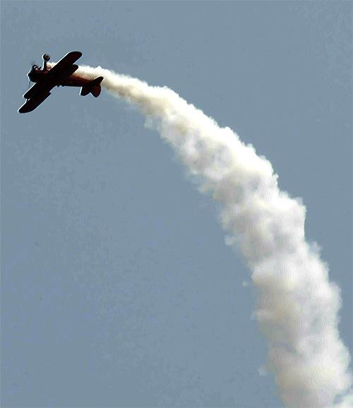 A biplane performs a barrell roll at the Arlington Fly-In July 9. The festival continues today and Saturday at the Arlington Airport.