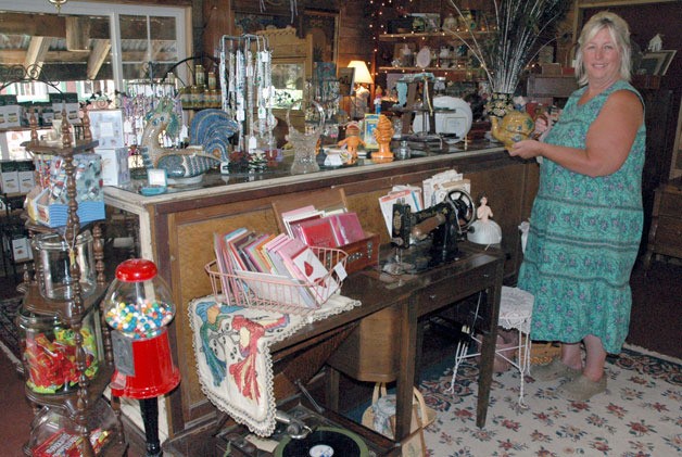 Carrie Snow shows off her wares in the antique store of the Mystic Mountain Nursery in Oso.