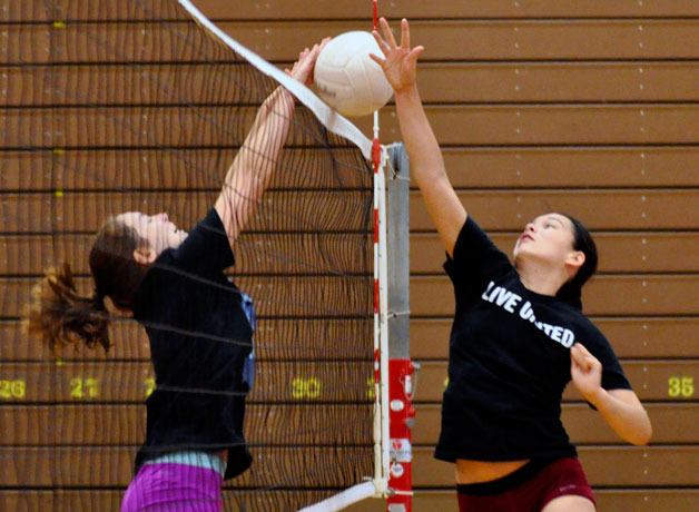 Lakewood’s outside hitter Jamie Cooper and setter Erin White practice during the first week of training on Thursday