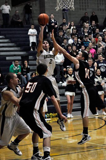 Senior Eric Carlson puts up a shot against Monroe.