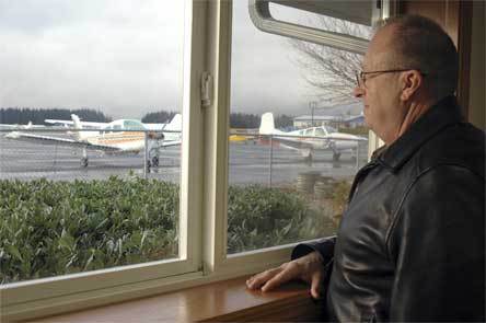 Arlington Municipal Airport manager Rob Putnam looks out the window of an office at the recently renovated aviation building on Monday