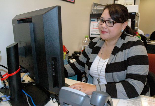 Veronica Villalobos’ desk is situated near the front of the client waiting area of the Sea Mar Community Health Center of Marysville