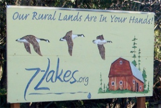 Two hand-painted signs depicting three Canada geese and a red barn and declaring â€śOur rural lands are in your handsâ€ť were stolen recently from Lakewood. Posted  outside of the Lakewood store by permission of the owner