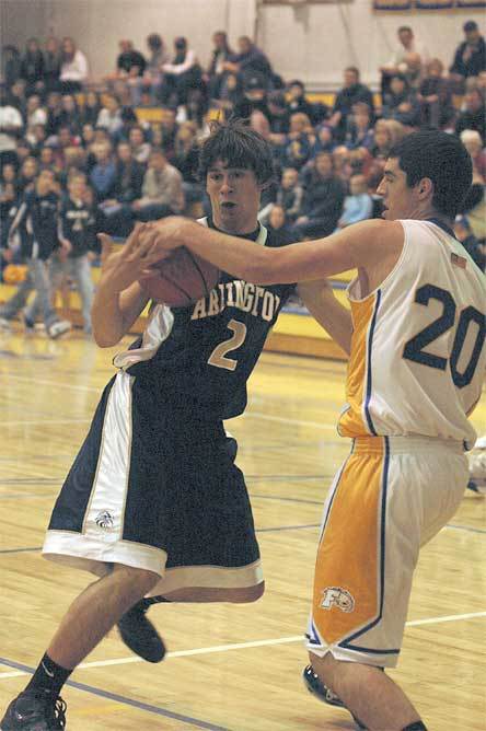 Junior guard Eric Carlson tangles with Ferndale defender Taylor Carr before scoring two of his 20 points Dec. 3.