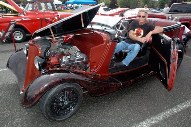 Arlington’s Craig Johnson shows off his souped-up 1933 Ford two-door sedan at the second annual area car and motorcycle show for Volunteers of America’s Ending Homelessness program on Aug. 24.