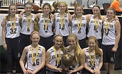 The championship AAU team from Arlington holds the trophy.