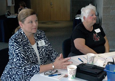 Arlington School District Superintendent Dr. Kris McDuffy and Board Vice President Kay Duskin listen attentively to the Washington State School Directors’ Association explanation of a proposed review rubric for superintendents at a joint school board meeting on May 11.