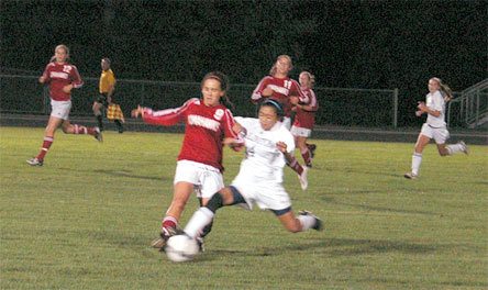 Sophomore forward Dana Canaria tries driving the ball against M-P defender Courtney Wear in the second half of the team's loss Sept. 10.