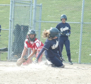 While the Stanwood catcher scrambles for the ball and the tag