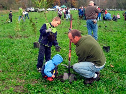 Volunteers plant native trees and shrubs along the South Fork of the Stillaguamish River at the new County Charm Conservation Area on Oct. 23.