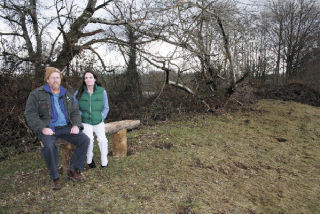 Bill Blake and Sarah Hegge rest on a bench built by Joel Larson for the new Eagle Trail.