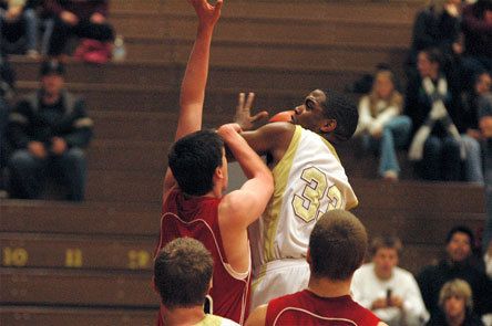 Junior Tre' Haslom absorbs the defense's contact and makes the basket while being fouled.