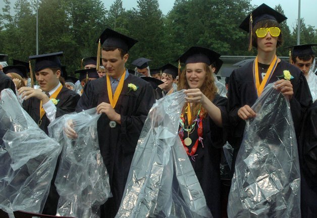 Arlington High School’s graduating seniors don ponchos to fend off a commencement ceremony deluged with rain on June 12.