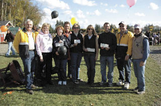 Representatives of the Arlington School District are flanked by members of the Marysville Noon Rotary as they brandish their checks from “Pumpkins for Literacy” at the Smokey Point Plant Farm Oct. 25.