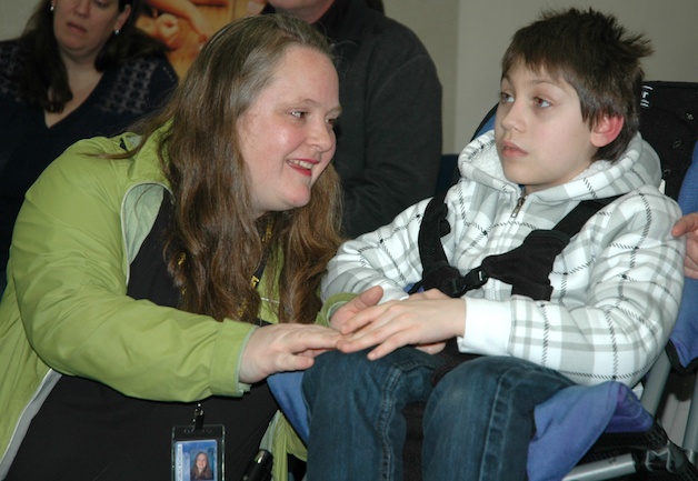 Pioneer Elementary Life Skills teacher Christie Britton comforts blind sixth-grader Mark Onyshchuk as she explains to the Arlington school board how his peer helpers have made a difference in the quality of his education and his life.