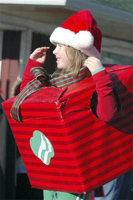A girl dressed as a present marches in the Hometown Holiday parade Dec. 5.