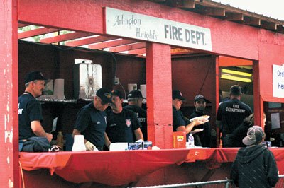 Members of the Arlington Heights Fire Department distribute freshly made pancakes hot off the griddle to a crowd at the Fourth of July Pancake Breakfast.