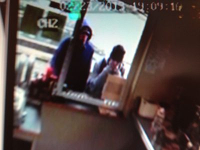 Security camera footage shows one suspect wearing a blue hoodie