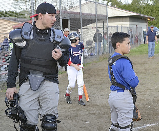 Few volunteer umpires mean coaches like Dan Lowes have to get behind the plate.