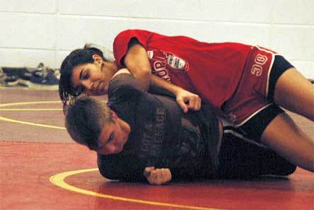 Nationally-ranked 130-pound wrestler Keely Caldwell practices an arm bar.