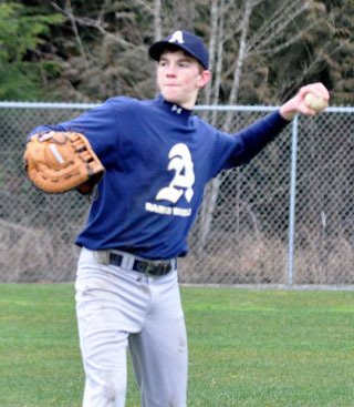 Arlington senior pitcher Austin Taylor warms up his arm with a game of long toss at the beginning of practice.