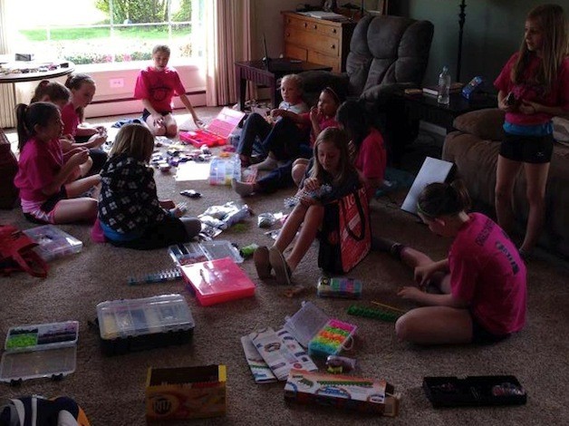 Members of the Arlington Premiere Volleyball and Basketball teams make rainbow loom rubber band bracelets to raise funds for survivors of the Oso slide.