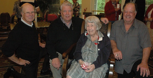 Mary Jane Case is flanked by her sons — from left