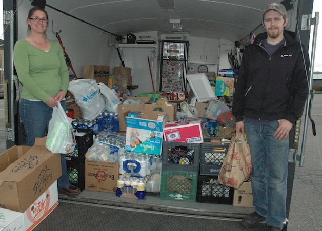 Amanda and D.J. Vickerman show off one of the four trailers that they and their fellow volunteers have filled up