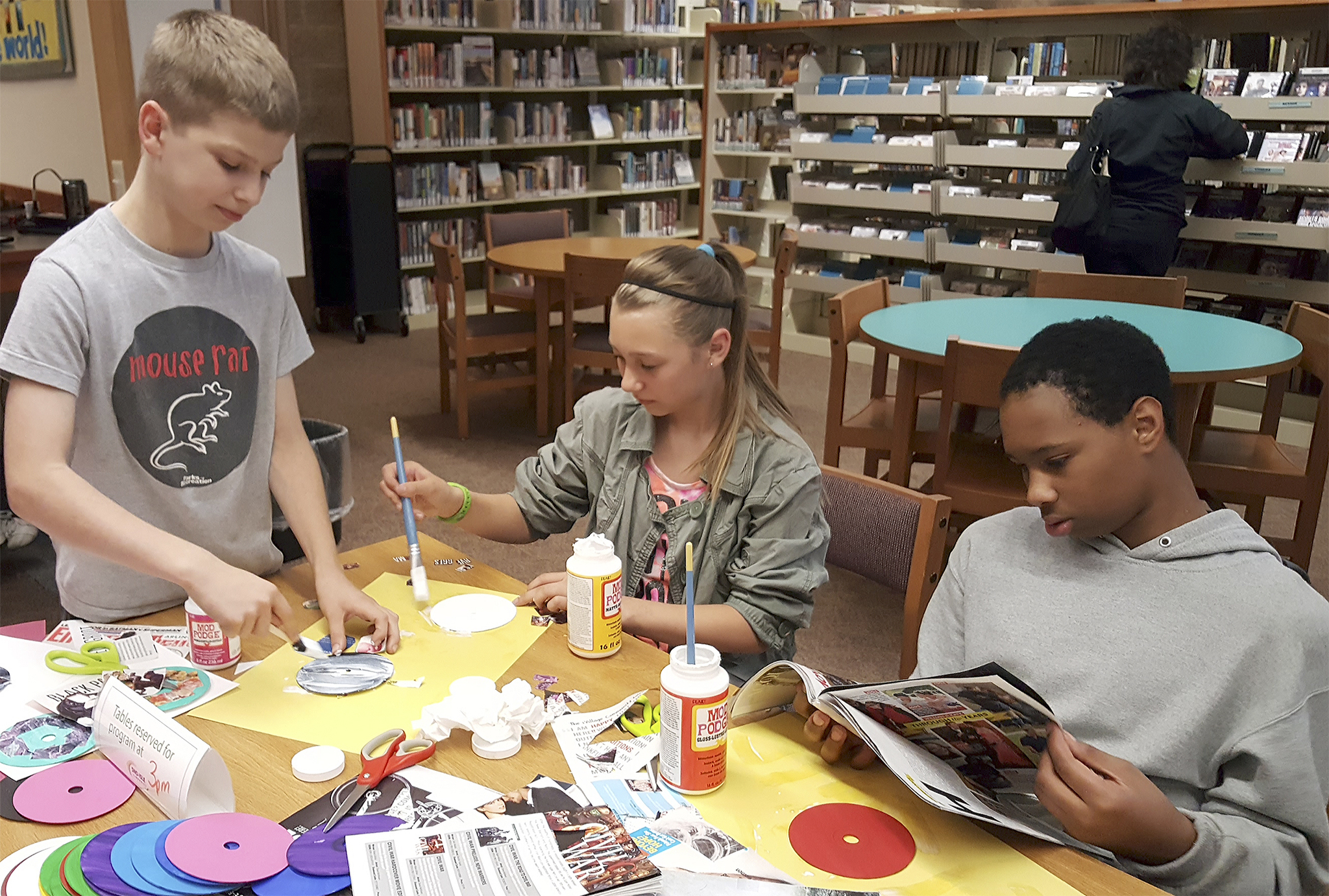Teens participate in a craft program at the Arlington Library recently. More events are planned for teens and younger children at the library this summer.